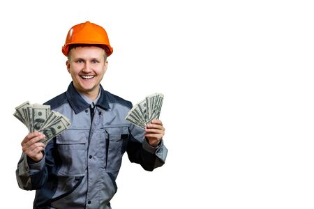 The builder in the orange helmet is incredibly rich. He received a large salary for repair work and now can celebrate. isolatedの写真素材