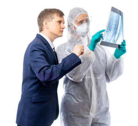 A specialist scientist intently examines a picture with an unknown person in a business suit. Isolated on a white background.の写真素材