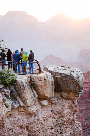 Tourists at Mather Point in Grand Canyon National Park South Rim, Arizona  looking at sunrise on skyline in the early morning.の写真素材