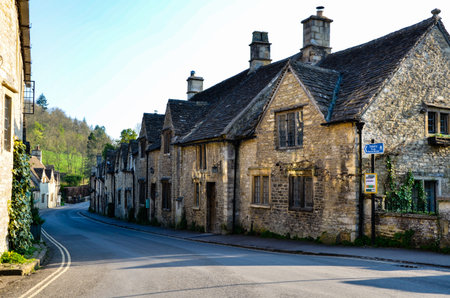 Main street to the countryside in Castle Combe, one of the quiet village in Cotswolds, England, with...