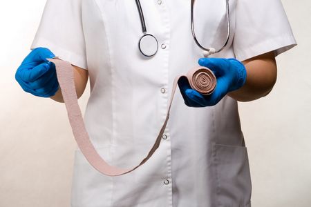 Medical nurse applying a bandageの写真素材