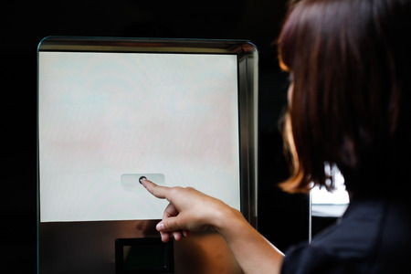 Woman touching the screen of vending machineの写真素材