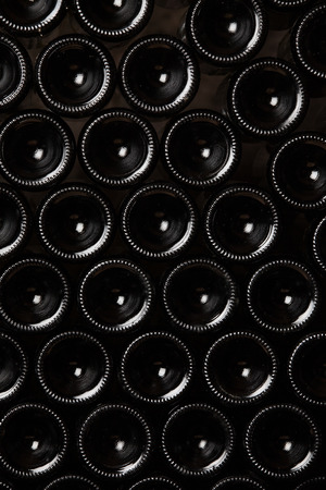 Bottoms of wine bottles. Creative dark and textured abstract background.の写真素材