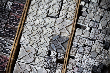 Old vintage metal printing press symbols in a drawer, close-up
