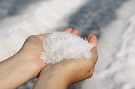 Woman holding a pile of freshly harvested salt