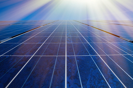 Solar panels, sun and blue skyの写真素材
