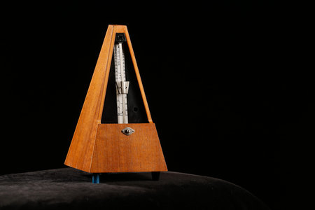 Mechanical metronome giving tact by ticking certain beats per minute with pendulum swing. Basic...