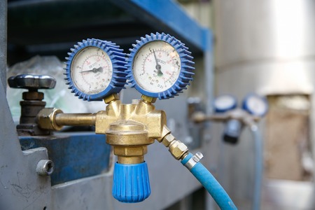 Heavy-duty dual industrial manometer, measuring pipeline/hose pressure, preventing over pressurization in machinery.の写真素材