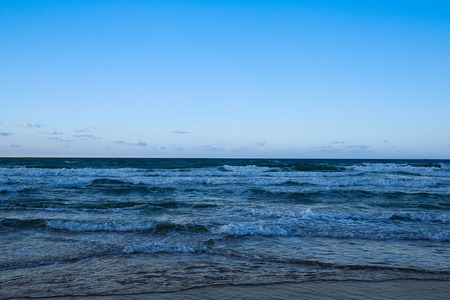 Vast blue ocean in evening light with waves coming in. Tranquil scenery, seacape background, infinity concept.の写真素材