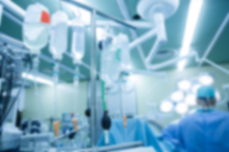 Abstract blurry medical background with IV bags and bottles hanging during a real surgery. Out-of-body experience, patient, anesthesia, hospital, medicine and health care symbolism and concept.の写真素材