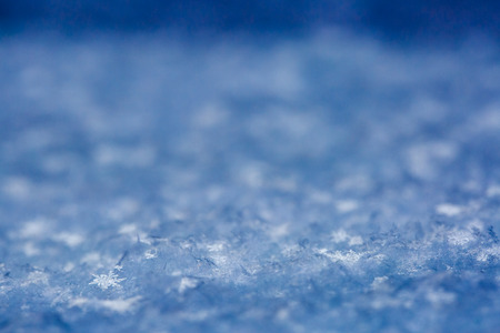Snowflakes on a snow cover. Textured background with copy space, winter concept. の写真素材