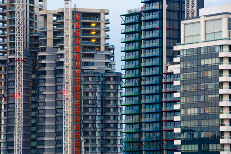 New skyscrapers under construction. Construction business and industry, urbanisation, urban sprawl...