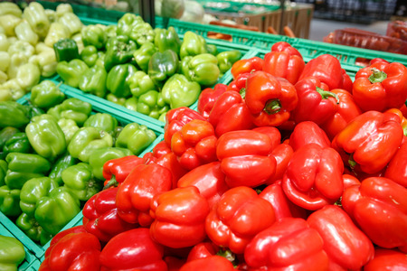 Unpacked, fresh and colourful peppers in a self-service supermarket. Zero-waste movement and philosophy, sustainable trade and organic grocery concept.の写真素材