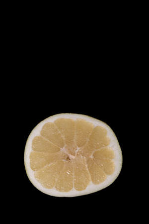 Cut pomelo on a black backgroundの写真素材