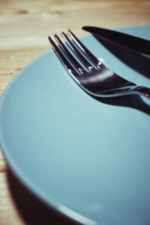 Cutlery and plates on a wooden background,の写真素材