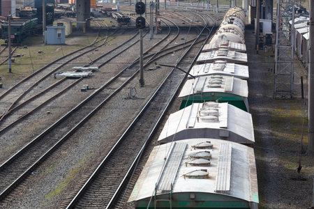 a freight train standing on the tracks waiting to be unloaded or loaded
