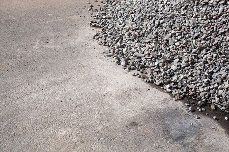 A bulk of gravel rock which is preparation for construction working site, material for building industrial. Close-up and selective focus at the center.の写真素材