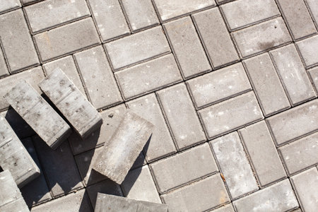 Laying gray paving tiles in the city. Repair of pavement