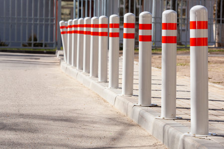 A barrier made of plastic columns with reflective pigment on an asphalt road. Danger concept. No...