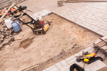repair of the sidewalk installation of new tiles on the prepared surface improvement of the urban...