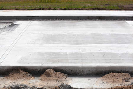 construction of a new road from concrete by technology, photo closeup from the construction siteの写真素材