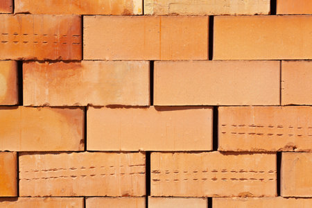 a large number of stacked bricks for building construction