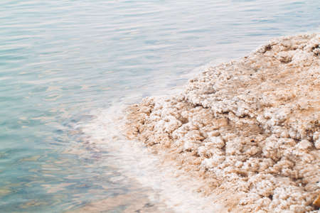 Rock covered with salt on coast of Dead sea, israelの写真素材