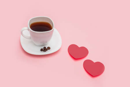 a cup of coffee with hearts made of red paper on pink background. Morning mood concept. love concept. Top view. flat lay. copy space. free space for textの写真素材