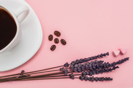 dry Lavender bouquet with a cup of coffee on pink background. Morning mood concept. Top view. flat lay. copy space. Morning mood concept. free space for textの写真素材
