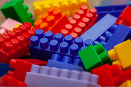 A colorful constructor set, which lies on the floor of a house, close-up. Educational games for...