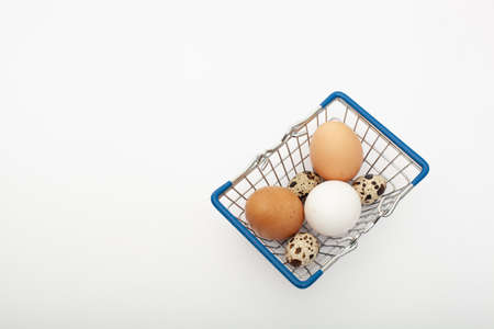 closup Brown and white chicken eggs in a shopping trolley isolated on a white backgroundの写真素材