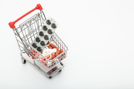 Pharmacy medicine. Shopping cart with pills and medical supplies. copy space for textの写真素材