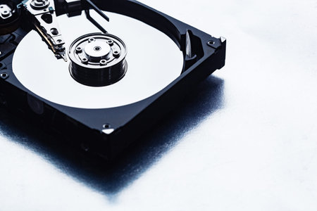 An open computer hard drive for repair. HDD. Components for ps. Storage and restoration of digital dataの写真素材