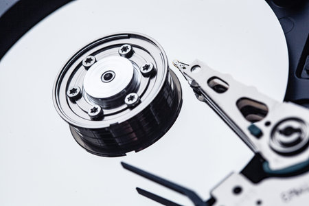 An open computer hard drive for repair. HDD. Components for ps. Storage and restoration of digital...
