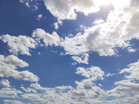 Blue sky with clouds and sunlights in the summer timeの写真素材