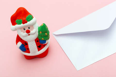 concept of writing and sending a letter to santa claus for the fulfillment of christmas and new year wishesの写真素材