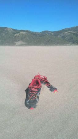 Shoes embedding in sand dunes