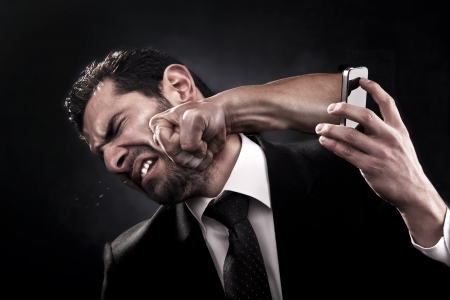 Man gets punched through a smart phone on the face by an angry callerの写真素材