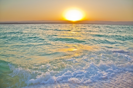 Small waves smashing against salty shores of the dead sea in Jordanの写真素材