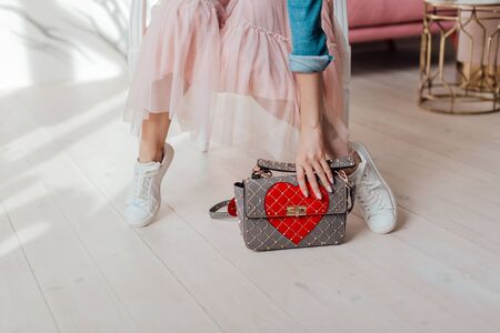 Multi-colored leather bags, in a room with a good interior and beautiful colored furniture, sometimes a girl is in the frameの写真素材