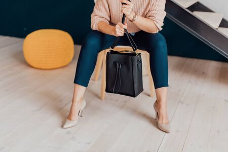 Multi-colored leather bags, in a room with a good interior and beautiful colored furniture, sometimes a girl is in the frameの写真素材