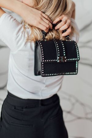 Multi-colored leather bags, in a room with a good interior and beautiful colored furniture, sometimes a girl is in the frameの写真素材