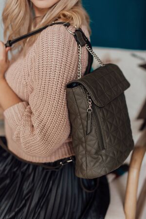 Multi-colored leather bags, in a room with a good interior and beautiful colored furniture, sometimes a girl is in the frameの写真素材