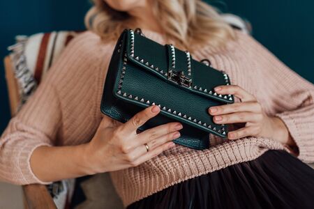 Multi-colored leather bags, in a room with a good interior and beautiful colored furniture, sometimes a girl is in the frameの写真素材