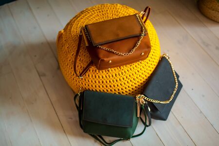 Multi-colored leather bags, in a room with a good interior and beautiful colored furniture, sometimes a girl is in the frameの写真素材