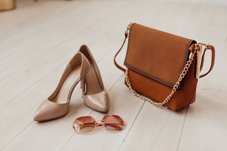 Multi-colored leather bags, in a room with a good interior and beautiful colored furniture, sometimes a girl is in the frameの写真素材