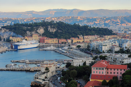 Old Nice district near bay with yachts and ferryのeditorial素材