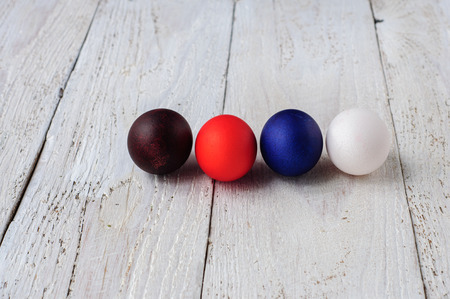 Colored easter eggs in line on wooden white shabby backgroundの写真素材