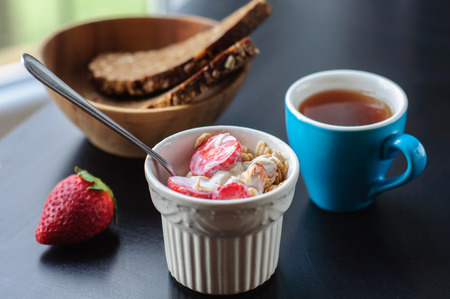 Cup of granola with strawberry and yogurt, coffeeの写真素材