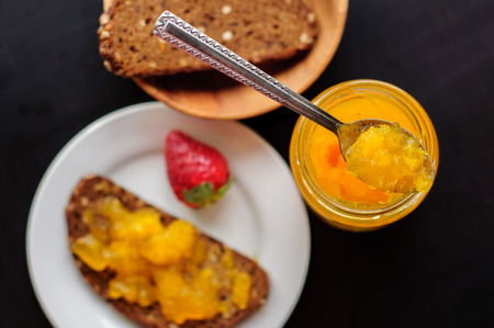Sandwich with rye bread and orange jelly for breakfastの写真素材